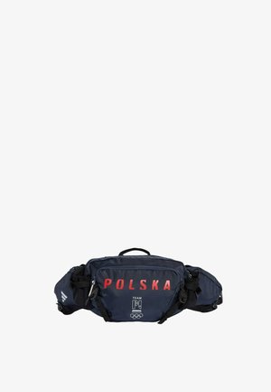 Granatowa nerka z czerwonym napisem "POLSKA", białym logo Drużyny Polski oraz czarnymi regulowanymi paskami na białym tle.