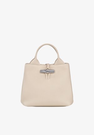Beige leather handbag with a textured finish, featuring a silver metal clasp and dual handles, designed in a structured shape.