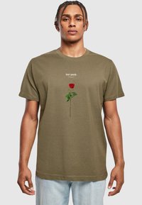 Olive green short-sleeve T-shirt featuring a red rose graphic with green leaves and the text "lost youth" above in a light font. Casual fit.