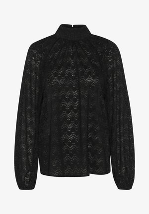 Mustast pitsakleidist, millel on kõrge kaelus, pikad varrukad ja tekstuuriga zikk-zakk muster. Kanga koostis on lühike ja voogav.