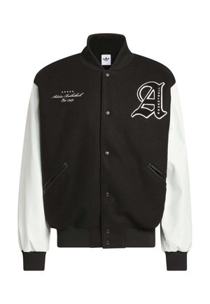 Black varsity jacket with white leather sleeves, ribbed cuffs, and hem. Features embroidered logo and text on the chest. Two side pockets.