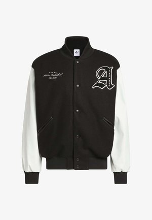 Black varsity jacket with white leather sleeves, ribbed cuffs, and hem. Features embroidered logo and text on the chest. Two side pockets.