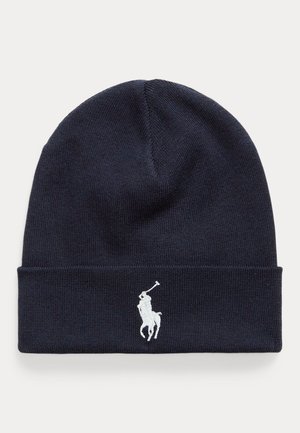 Navy knit beanie made from soft material, featuring a white embroidered polo logo on the front and a folded cuff design.