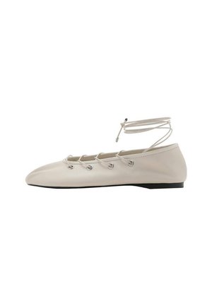 Beige flat shoe with a pointed toe, leather material, lace-up design with eyelets, and a slim black sole. Features a wrap-around ankle strap.