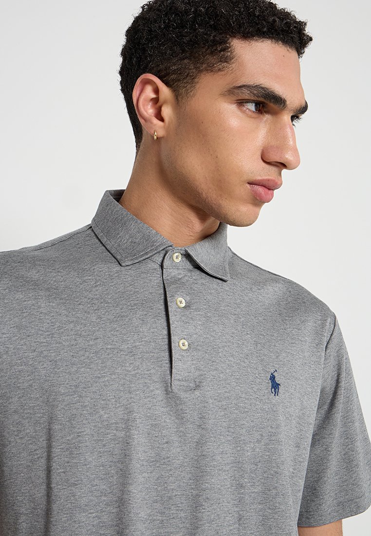 Polo gris de mezcla de algodón, con un cuello clásico, tapeta de tres botones y logotipo bordado en azul marino en el lado izquierdo del pecho.