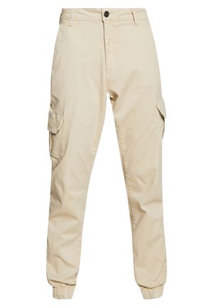 Pantalones cargo beige con un corte clásico, que cuentan con dos bolsillos laterales, puños elásticos y una suave tela de algodón con una textura lisa.