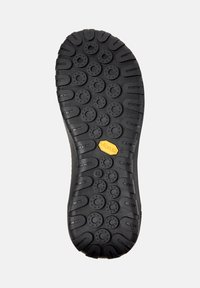 Suela de zapato de goma negra con dibujos de patrones circulares y ovalados, con un logo de Vibram en amarillo. Talla 42 marcada en el costado.
