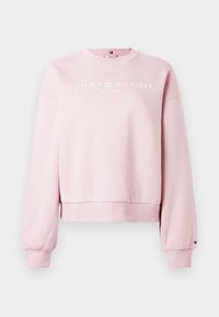 Rózsaszín, vágott pulóver, pamut anyagból készült, kerek nyakkivágással, hosszú ujjakkal és a mellkason fehér "TOMMY HILFIGER" felirattal.
