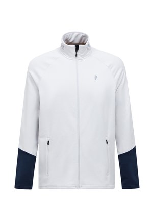 Hvid zip-up jakke med høj krave, marineblå accentpaneler på ærmerne og to sidelommer med lynlås. Blødt, glat materiale med logo-detalje.