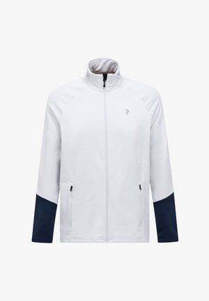 Hvid zip-up jakke med høj krave, marineblå accentpaneler på ærmerne og to sidelommer med lynlås. Blødt, glat materiale med logo-detalje.