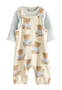 Jaune pâle avec motif d'ours, chemise à manches longues rayée bleu et blanc ; détails en boutons en bois, poignets élastiques aux chevilles.