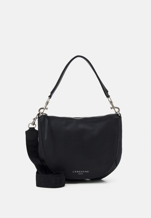 Musta nahkainen olkalaukku pyöreällä muotoilulla, jossa on vetoketjusuljin, pitkä olkahihna ja kohokuvioitu merkkilogo etupuolella.