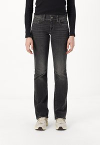Black denim jeans with a slim fit and slightly flared legs. Features slight fading, classic five-pocket design, and button closure.