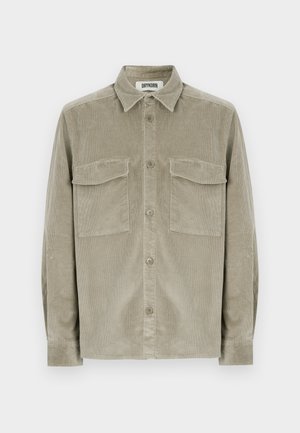 Olive green corduroy shirt with long sleeves, button-up front, and two chest pockets. Soft texture with a classic collar design.