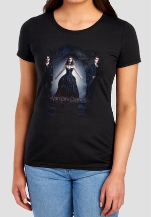 Black T-shirt featuring three characters from The Vampire Diaries, with a gothic arch background and dark, dramatic clothing.