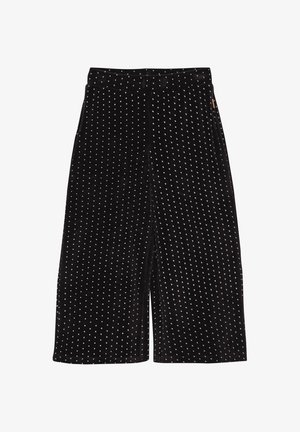 Zwarte wijde broek met witte stippen, elastische tailleband en zijzakken, weergegeven op een witte achtergrond.