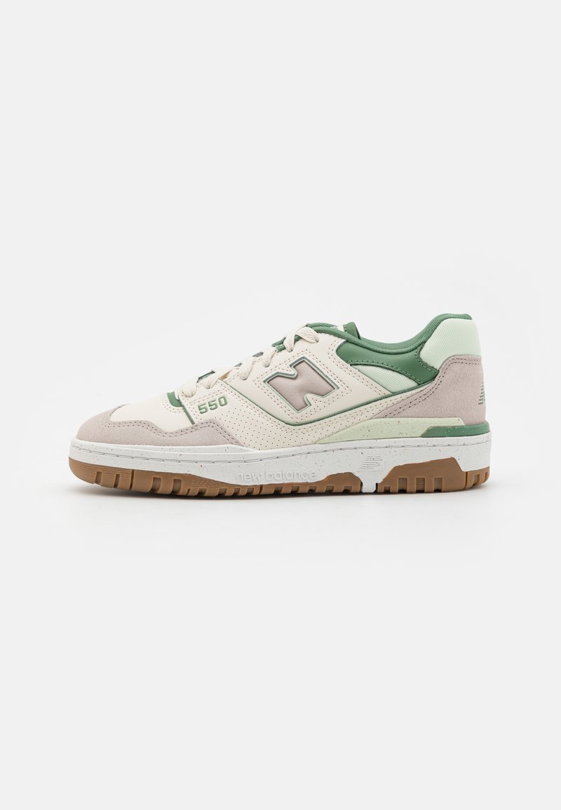 White and green New Balance 550 sneaker with beige suede accents and gum rubber sole, facing right on a plain white background.