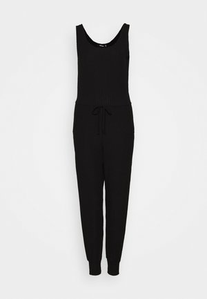 Mono negro de canalé con escote redondeado, cuerpo ajustado, cintura con cordón ajustable y puños en los tobillos ajustados. Fabricado en un material suave y elástico.