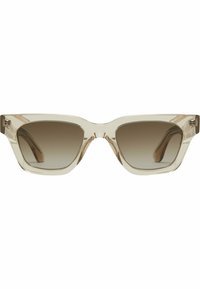 Lunettes de soleil transparentes beige avec un design géométrique et angulaire, dotées de verres dégradés sombres et de matériel métallique visible aux charnières.