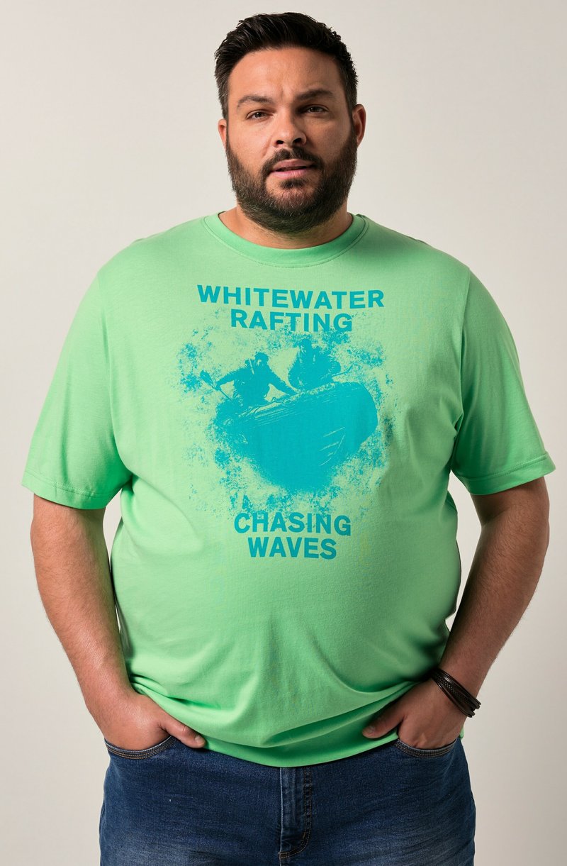 Light green cotton t-shirt with a graphic print of kayakers and text "WHITEWATER RAFTING CHASING WAVES" in bold blue letters.