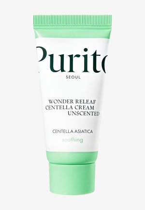 Tube med Purito Wonder Releaf Centella Cream, uden duft, med grøn hætte og top, indeholdende Centella Asiatica til beroligende hudpleje.