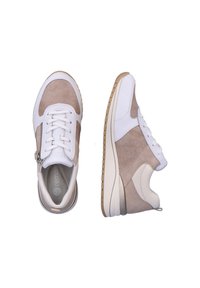 Deux baskets avec une tige en tissu beige et cuir blanc, présentant un design texturé, des fermetures à lacets et à zip, et une semelle de couleur claire.