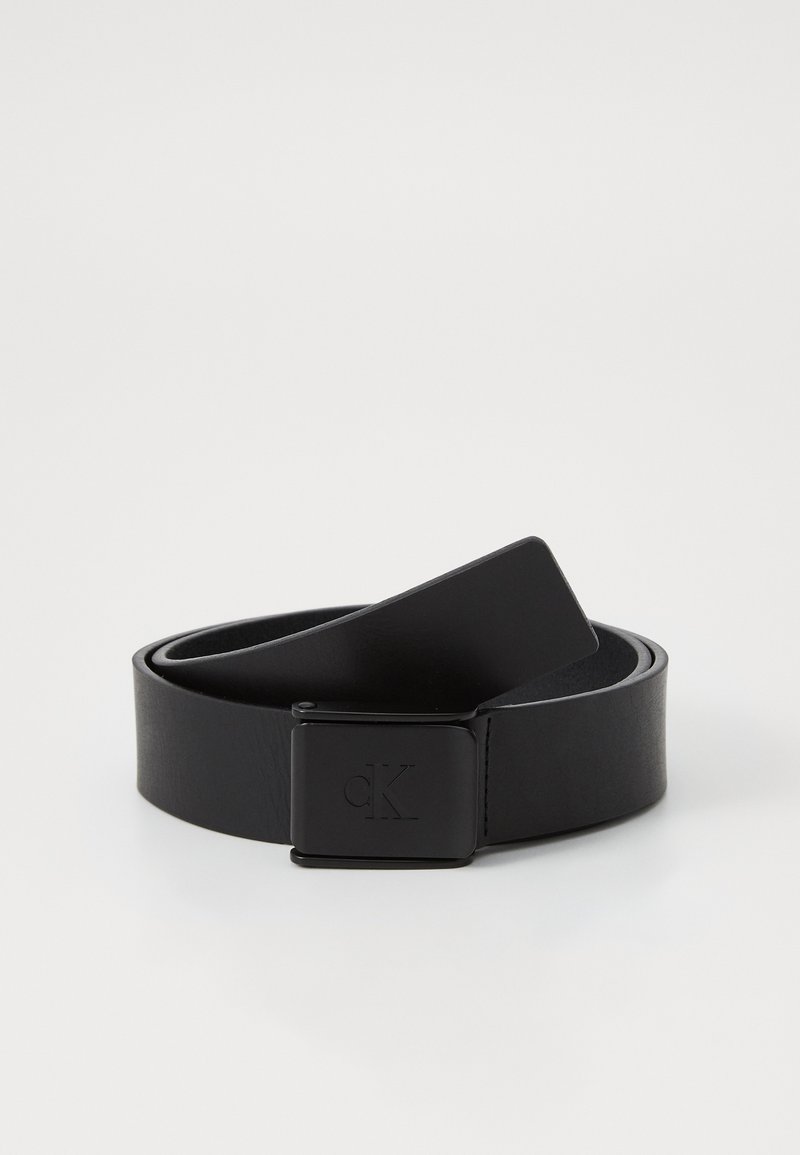 Black leather belt with a smooth texture, featuring a square metal buckle with an embossed logo. Classic design with a sleek finish.