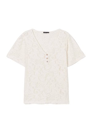 Haut en dentelle blanche avec un décolleté en V, des manches courtes et trois boutons décoratifs à l'avant. Présente un motif floral sur l'ensemble.