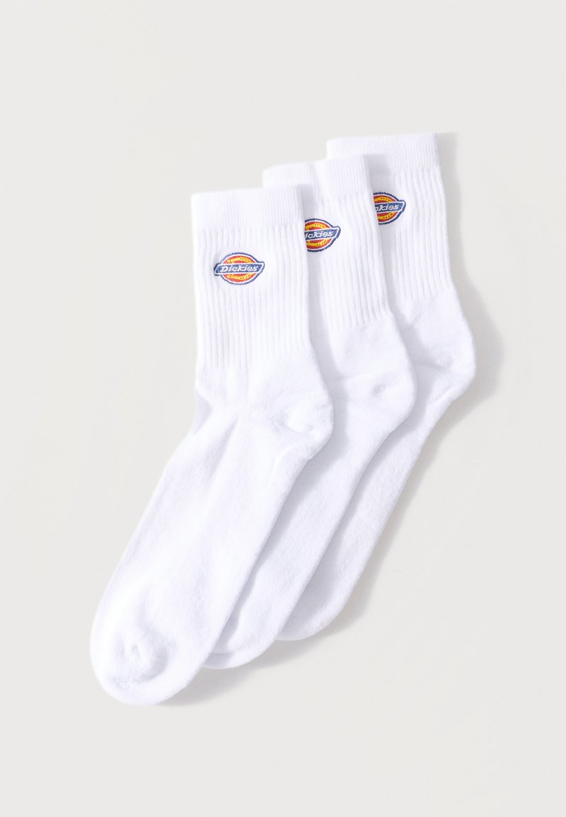Three pairs of white crew socks with ribbed cuffs and a colorful Dickies logo patch on the outer side near the top.