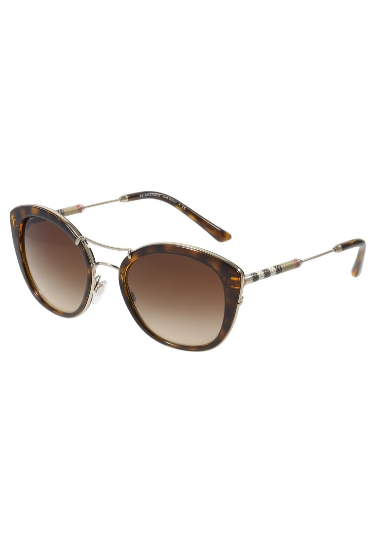 Ochelari de soare tip cat-eye din tortoiseshell cu lentile maronii degradate și accente subțiri din metal auriu. Brațele texturate prezintă detalii colorate.