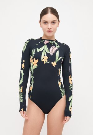 Maillot de bain noir à manches longues avec des motifs floraux colorés dans des tons de vert et d'orange, au design ajusté et avec des découpes sur les côtés.