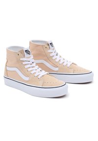 Høye sneakers i myk beige semsket skinn med hvite detaljer, flate hvite lisser, svart såle og sømdetaljer på overdelen.