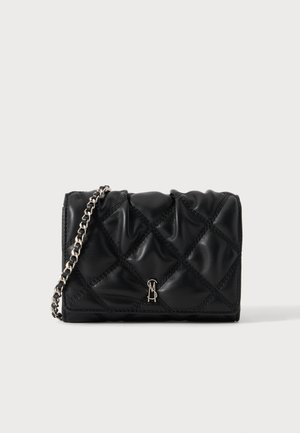 Black quilted leather handbag with silver chain strap and small metal logo on front, set against a plain light background.