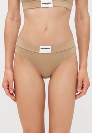 Beige DSQUARED2 bikini with a wide waistband, soft fabric, minimal coverage, and a black logo tag at the front. Smooth, stretchy texture.