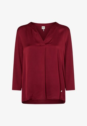 Burgunderfarbene Bluse mit Dreiviertelärmeln, V-Ausschnitt, vorderem Falten-Detail und abgerundetem Saum. Hergestellt aus glattem, leichtem Stoff.