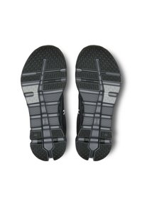 Suole di scarpe da corsa nere con motivi di battistrada testurizzati, dotate di un pannello grigio liscio e scanalature per flessibilità e aderenza.