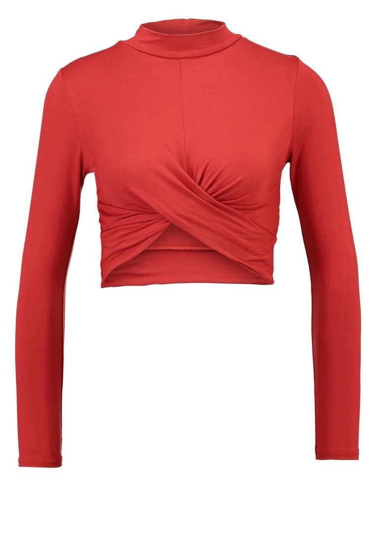 Red long-sleeve crop top featuring a high neckline, twisted front detail, and smooth, stretchy fabric for comfort.