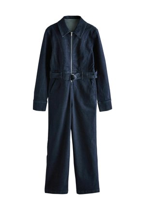 Navy blue denim jumpsuit with a structured collar, front zipper, belted waist, and long sleeves. Features side pockets and wide legs.