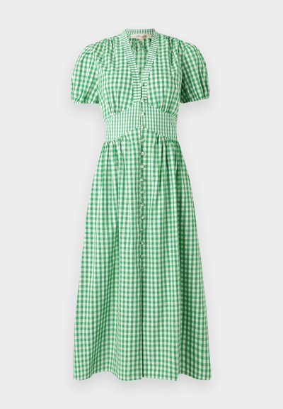 Zelena karirana obleka s kratkimi napihnjenimi rokavi, oprijetim telesom in gumbom po sprednji strani. Krilo preide v dolžino midi.