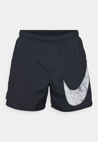 Mustat uimaportsit, jotka on valmistettu kevyestä kankaasta. Oikealla puolella on suuri valkoinen Nike Swosh -logo ja joustava vyötärö.