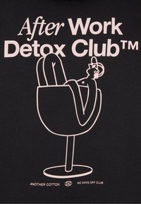 Black cotton t-shirt featuring white graphic text "After Work Detox Club™" and a minimalist outline of a person relaxing in a chair.