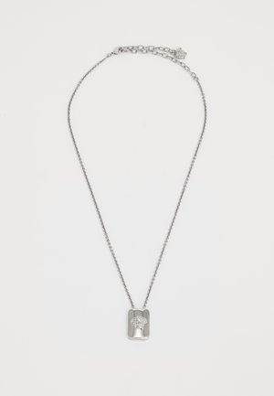 Silver necklace with a textured chain and a rectangular pendant featuring a raised design of a head. Adjustable length with a clasp.