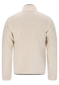 Beige fleecjacka med en mjuk, texturerad yta, med långa ärmar och hög krage. Vid nederkanten har den en rak klippning.