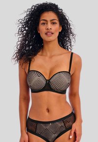 Conjunto de sujetador y bragas en negro con un patrón de chevrón, paneles transparentes, soporte de aros y tirantes ajustables. Tela texturizada con un acabado suave.