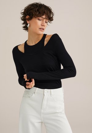 Zwarte top met lange mouwen en een ronde halslijn, voorzien van zijuitsparingen, gecombineerd met witte jeans met een hoge taille. Soepele textuur, aansluitend ontwerp.