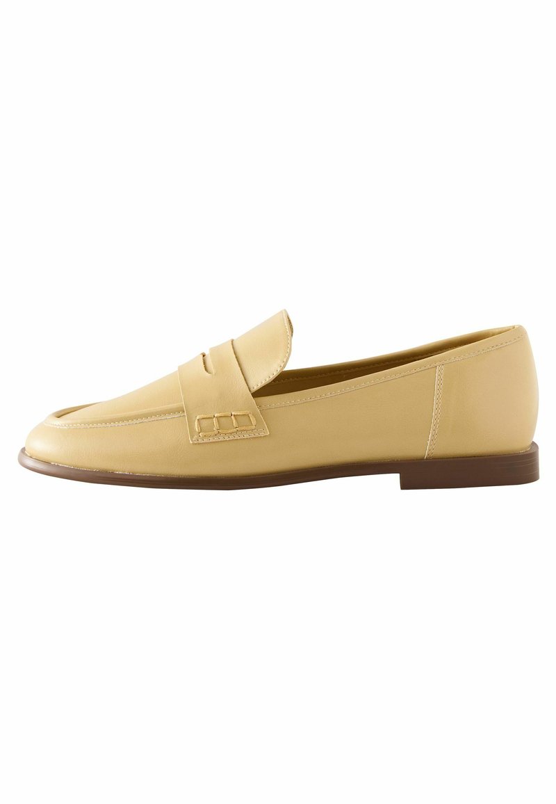 Yellow leather loafer with a rounded toe, decorative strap detail, and a flat brown sole. Smooth texture with simple stitching accents.