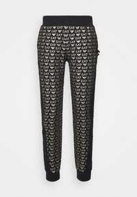 Pantalones jogger negros ajustados con estampado de logotipos EA7 en plata por toda la prenda, cintura elástica y tobillos ajustados.