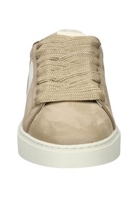 Beige suede sneaker with a white leather accent, thick textured laces, and a rubber sole. Rounded toe and minimal design details.