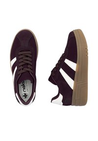 Dark purple suede sneakers with white leather stripes, brown laces, and a rubber gum sole featuring a logo on the side and cushioned insole.
