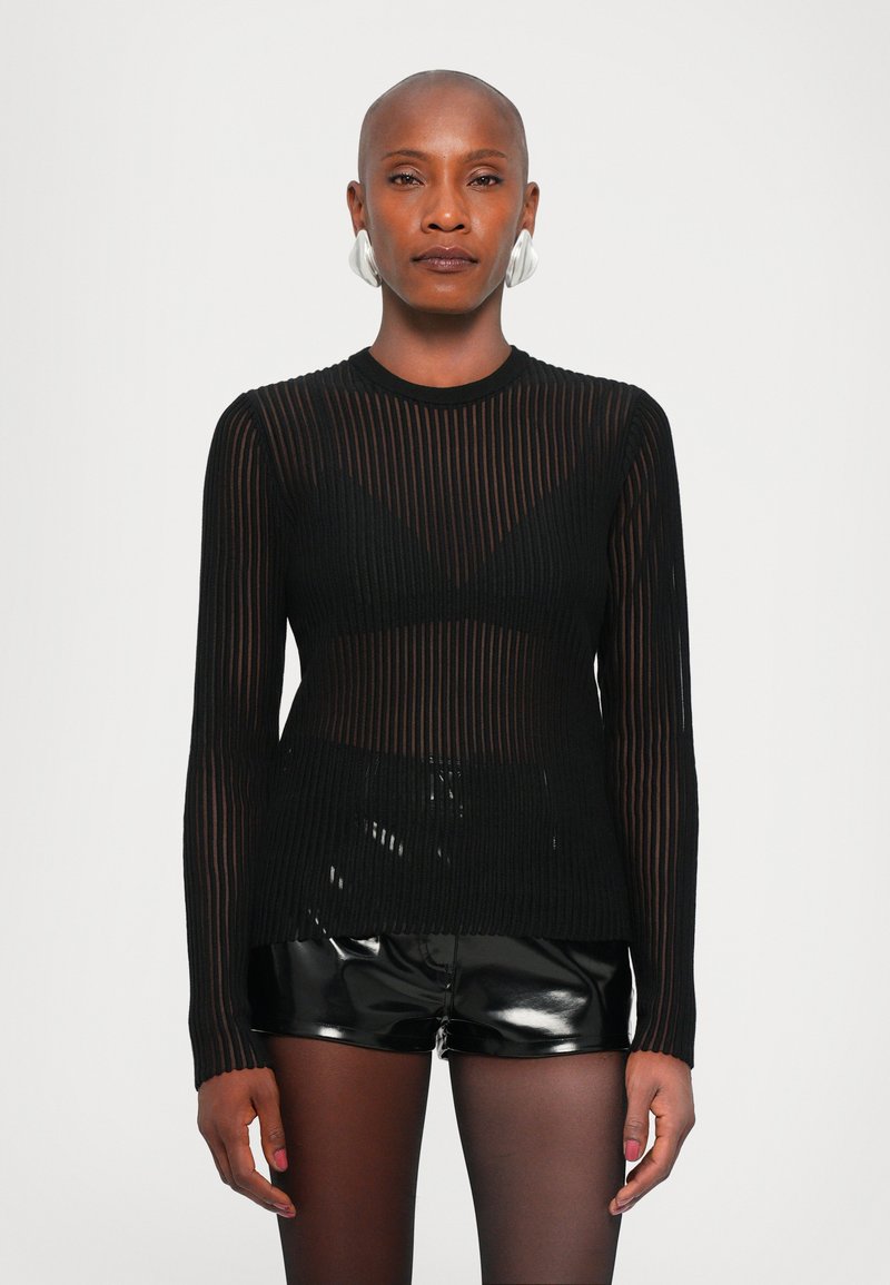 Black long-sleeve top with vertical stripes, made of sheer material, paired with high-shine black shorts. Features a fitted silhouette.